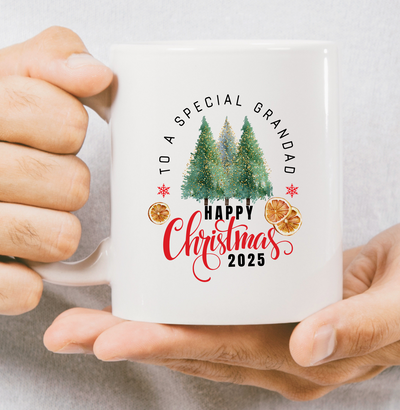 Person holding a Christmas-themed mug with text and tree design