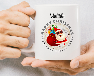 Person holding a mug with a Christmas design and text on a white background