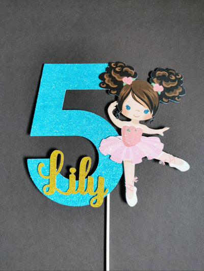 cake topper number '5' with a ballerina figure on a gray background