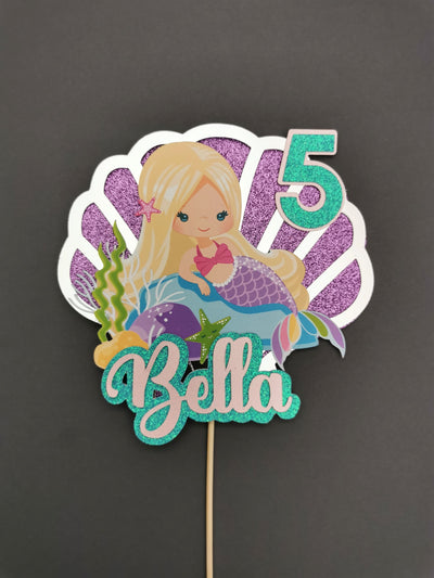 Mermaid-themed birthday cake topper with number 5 and name Bella on a dark background