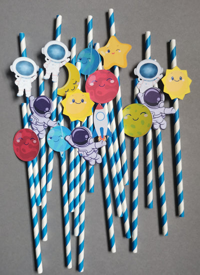 Straw decorations with cartoon solar system characters on a gray background