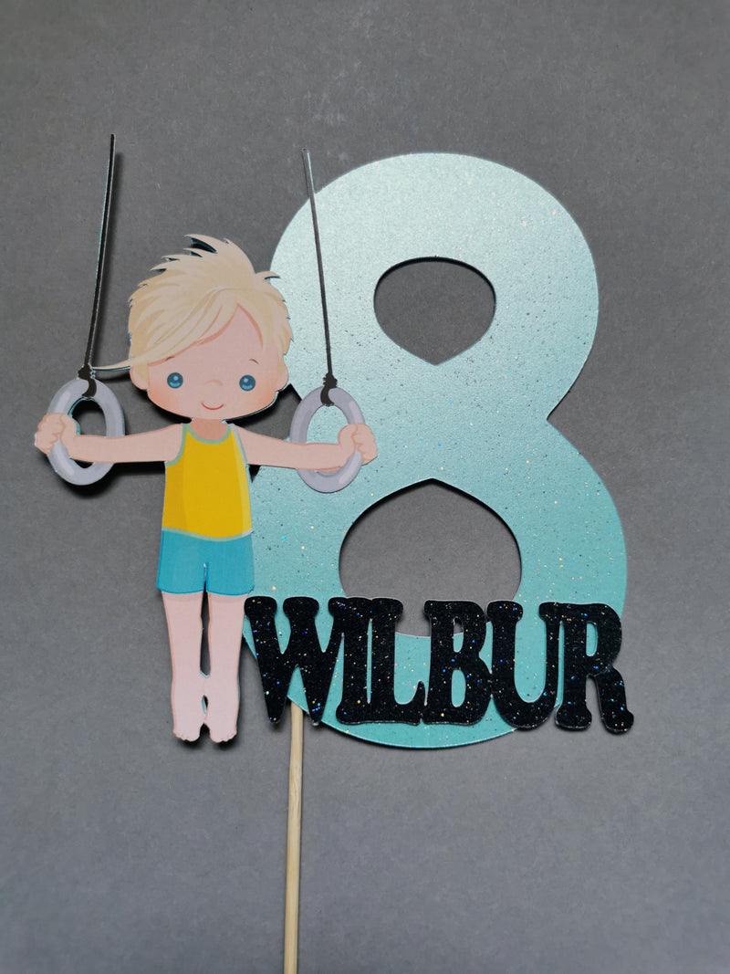 Decorative cake topper with a boy holding rings and the number 8 with &