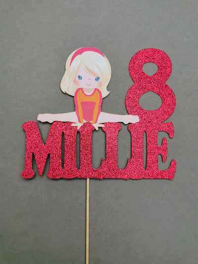 Cake topper with a gymnast figure and the number 8 on a gray background