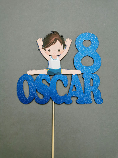 Cake topper with a male gymnast sitting on a name text on a gray background