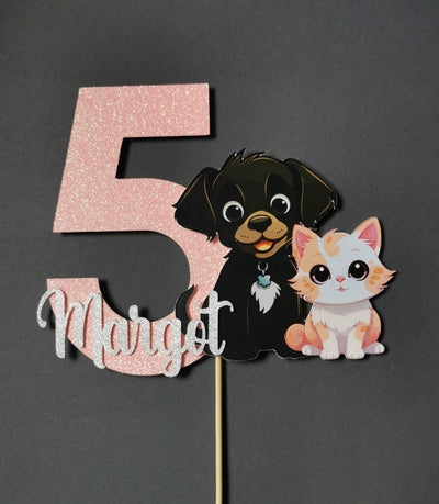 Number 5 cake topper with a dog and cat design on a gray background