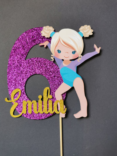 Gymnast-themed number 6 cake topper with 'Emilia' on a gray background