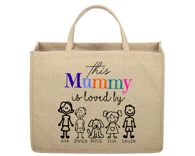 Beige tote bag with colorful text and stick figure illustrations on a white background