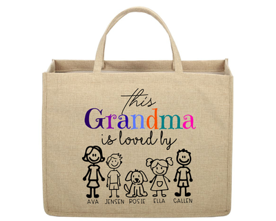 Beige tote bag with colorful text and stick figure family design on a white background