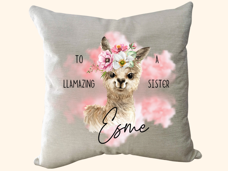 Pillow with a llama illustration and text on a light background