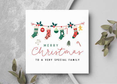 Christmas card with stockings and 'Merry Christmas to a very special family' text on a gray background.