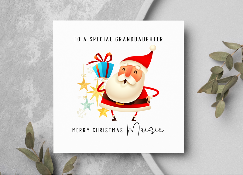 Christmas card with Santa Claus illustration and personalized text on a gray surface.