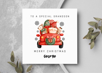 Christmas card for a special grandson with a red truck and Santa Claus illustration on a gray background.