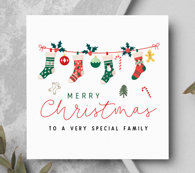 Christmas card with stockings and 'Merry Christmas to a very special family' text on a gray background.