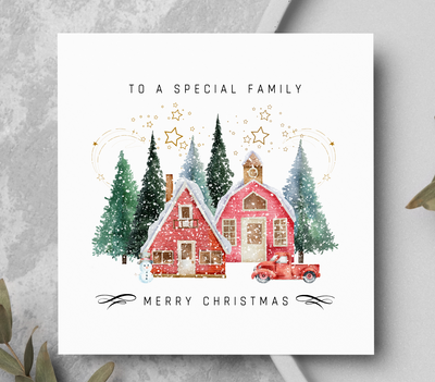 Christmas card showing pine trees, houses, truck and snowman.
