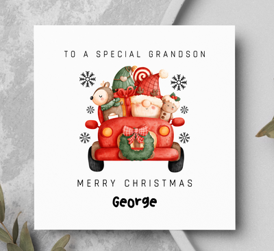 Christmas card for a special grandson with a red truck and Santa Claus illustration on a gray background.